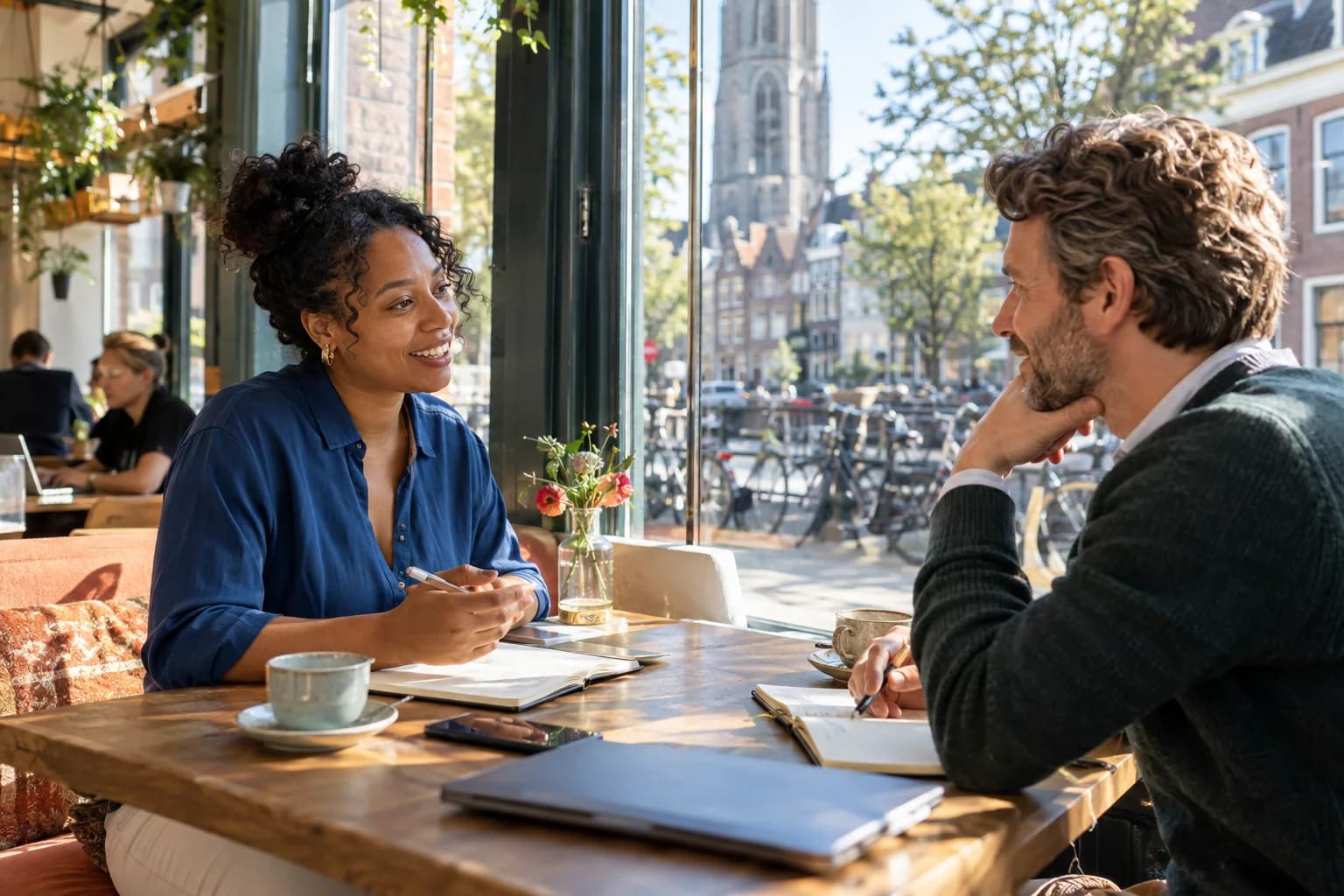 Candidate and recruiter in an open conversation in a sunlit Dutch city